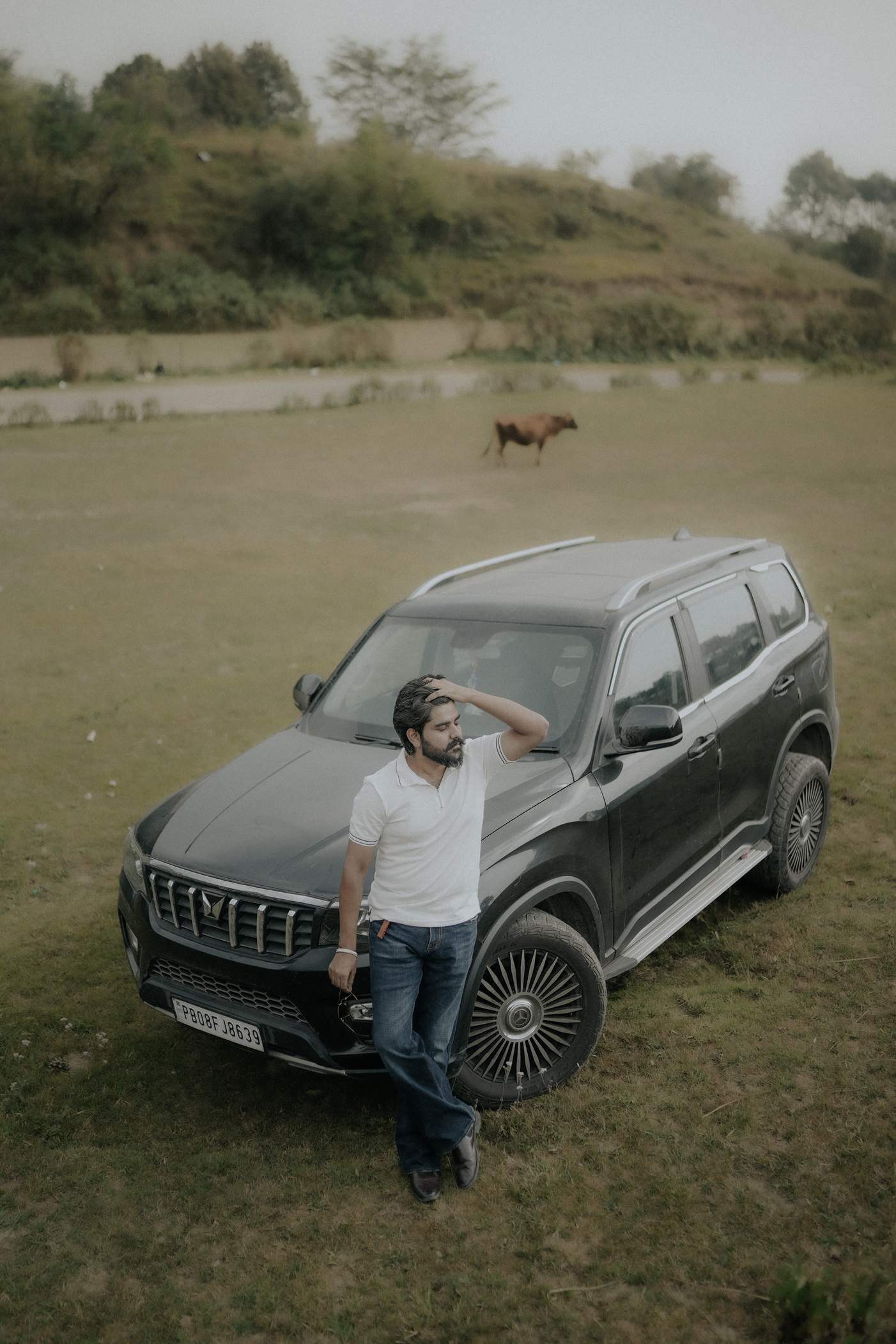 Editorial portrait beside a car
