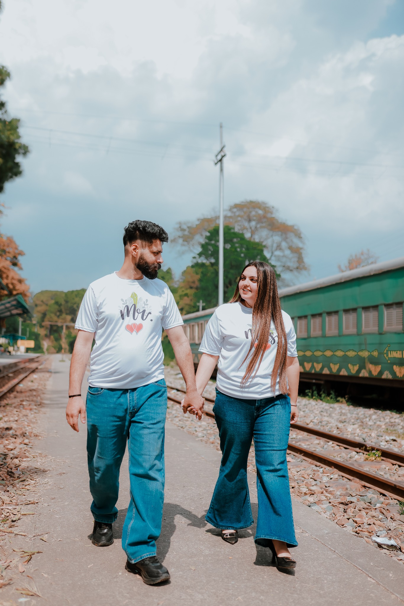 Couple walking beside railway tracks for pre-wedding shoot