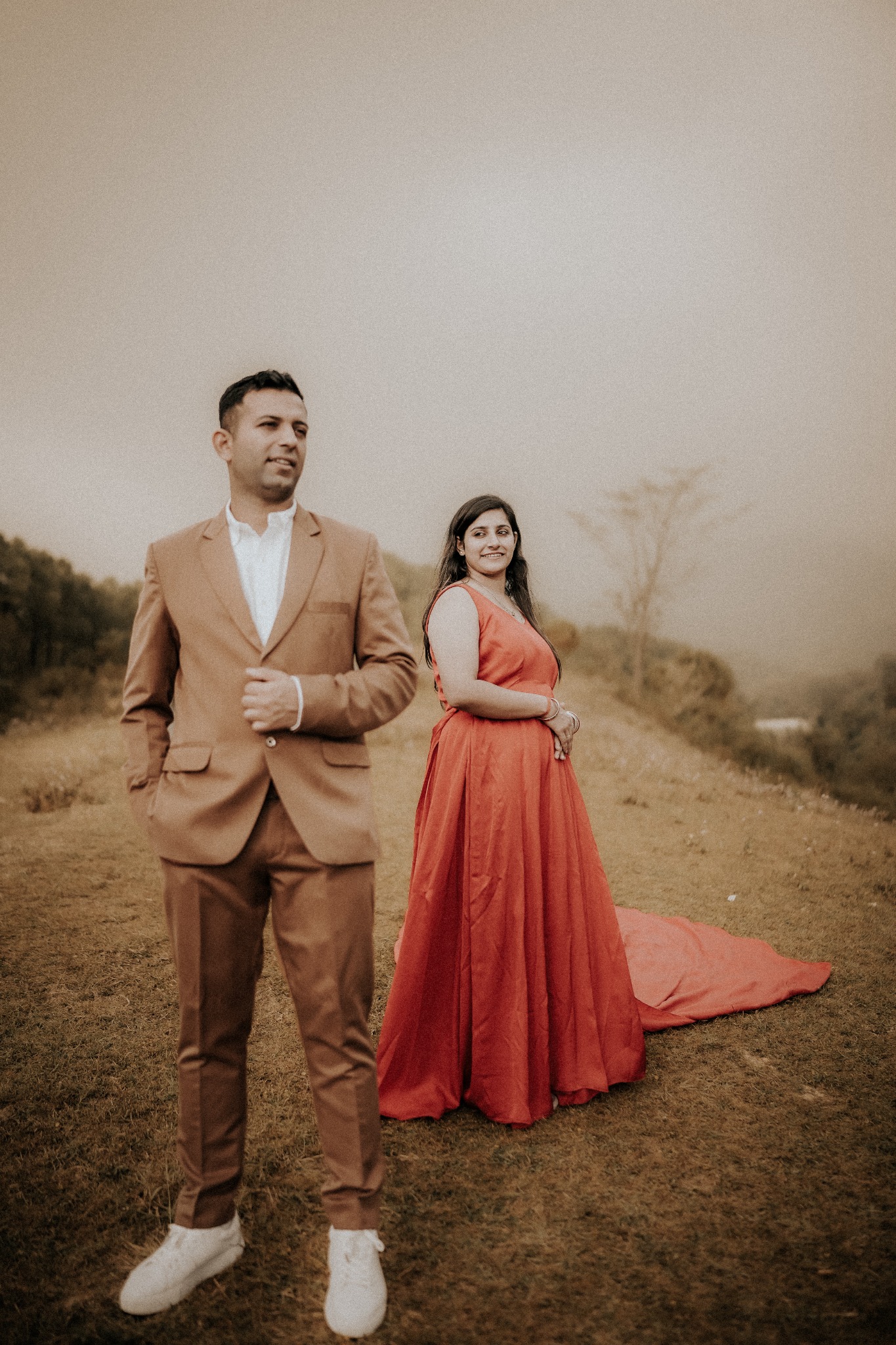 Couple portrait in a field at golden hour
